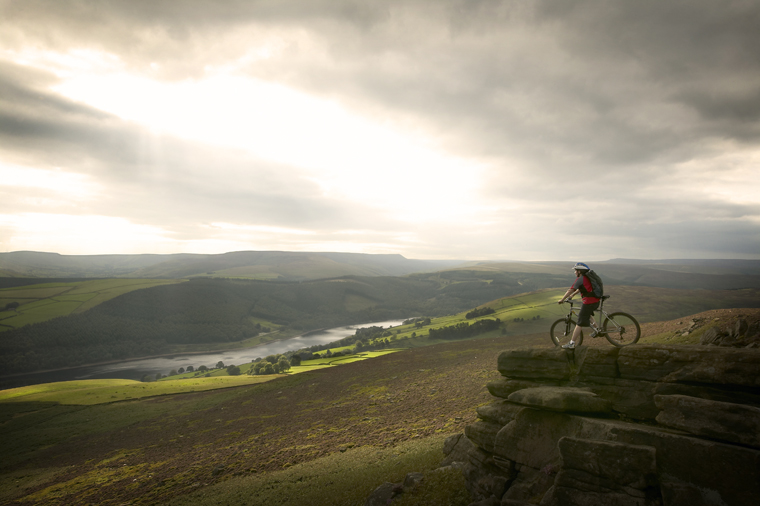 VisitBritain Daniel BosworthA lone cyclist taking in the spectacular view of the Peak District from the top of Whinstone Lee Tor Additional CreditEast Midlands Tourism