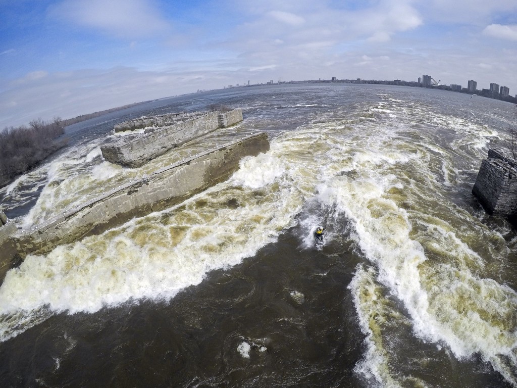 British kayaker Seth Ashworth surfs the Ruins Wave with Ottawa in the background