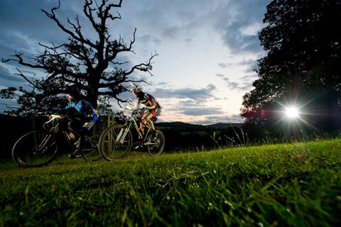 photograph at dusk of a mountain biker and photographer's flash