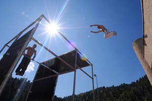 Man jumping over a gap with sun in the background at Urban Plagne